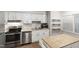 Well-lit kitchen features stainless steel appliances, white cabinetry, and ample counter space at 310 Bay Dr, Cary, NC 27511