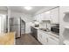 Bright kitchen features stainless steel appliances and ample cabinet space for storage at 310 Bay Dr, Cary, NC 27511
