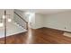 Bright living room area featuring a wooden staircase, hardwood floors, and light walls at 310 Bay Dr, Cary, NC 27511