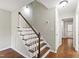 Bright staircase landing with hardwood stairs and floors, leading to hallway and other rooms at 310 Bay Dr, Cary, NC 27511
