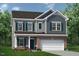 Charming two-story home with brick accents, a welcoming front porch, and a two car garage at 32 Freedom Heights Ln # 151, Smithfield, NC 27577