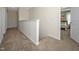 Neutral hallway with carpeted floors leading to a bedroom with decoratively pillowed bed and a ceiling fan at 32 Freedom Heights Ln # 151, Smithfield, NC 27577