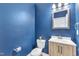 Stylish half-bathroom with blue walls, modern vanity, and contemporary fixtures at 3449 S Beaver Ln, Raleigh, NC 27604