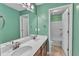 Bright bathroom with a double sink vanity, a large mirror, and a separate toilet and shower area at 3449 S Beaver Ln, Raleigh, NC 27604