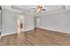 Large bedroom featuring a tray ceiling, neutral color scheme, and views of the home's exterior at 3449 S Beaver Ln, Raleigh, NC 27604