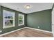 Bedroom features a light fixture, two windows and wood look flooring at 3449 S Beaver Ln, Raleigh, NC 27604