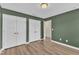 Bedroom with a light fixture, closet and wood look flooring at 3449 S Beaver Ln, Raleigh, NC 27604