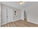 Bedroom with a fun mural, wood look flooring and a ceiling light at 3449 S Beaver Ln, Raleigh, NC 27604