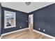 A bedroom features blue accent wall and natural light, creating a serene space at 3449 S Beaver Ln, Raleigh, NC 27604