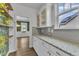 Bright butler's pantry with white cabinets, granite counters, and view to dining room at 3449 S Beaver Ln, Raleigh, NC 27604