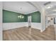 Dining room features wood-look flooring, wainscoting, and a stylish chandelier at 3449 S Beaver Ln, Raleigh, NC 27604