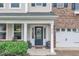 Inviting entrance with a dark blue front door, white trim, and charming landscaping at 3449 S Beaver Ln, Raleigh, NC 27604