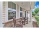 Relaxing front porch features rocking chairs and views of the home's facade at 3449 S Beaver Ln, Raleigh, NC 27604