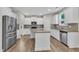 Spacious kitchen features stainless appliances, granite island, and modern white cabinetry at 3449 S Beaver Ln, Raleigh, NC 27604