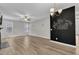 Open living room with ceiling fan, modern light fixture, and decorative chalkboard wall at 3449 S Beaver Ln, Raleigh, NC 27604