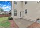 Concrete patio with a brick border outside the back of a vinyl sided house and lush green lawn at 3449 S Beaver Ln, Raleigh, NC 27604