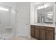 Bathroom featuring a glass enclosed shower, single vanity with a large mirror, and a neutral color palette at 347 N. Maple Walk Dr # 211, Garner, NC 27529