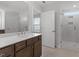Modern bathroom featuring a double vanity with a large mirror, a glass shower, and a neutral color palette at 347 N. Maple Walk Dr # 211, Garner, NC 27529