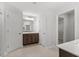 Bright bathroom featuring double vanity, large mirror, and neutral tile flooring at 347 N. Maple Walk Dr # 211, Garner, NC 27529