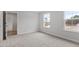 Light-filled bedroom showcasing neutral walls, carpet, and natural light from the two windows at 347 N. Maple Walk Dr # 211, Garner, NC 27529
