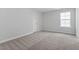 Bedroom with plush carpet and a large window, creating a cozy and comfortable space at 347 N. Maple Walk Dr # 211, Garner, NC 27529