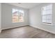 Bright bedroom featuring hardwood floors and large windows providing plenty of natural light at 347 N. Maple Walk Dr # 211, Garner, NC 27529