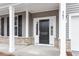 Close-up of the front door featuring a black door with white trim, stone accents, and the house number at 347 N. Maple Walk Dr # 211, Garner, NC 27529