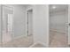 Hallway featuring a large mirror and an entry to the walk-in closet with ample storage at 347 N. Maple Walk Dr # 211, Garner, NC 27529