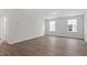 Spacious living room featuring hardwood flooring and neutral walls, perfect for versatile living arrangements at 347 N. Maple Walk Dr # 211, Garner, NC 27529