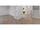 Spacious living room with hardwood floors, white walls, and french doors that lead to an office space at 347 N. Maple Walk Dr # 211, Garner, NC 27529