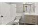 Bright bathroom featuring tub, shower, toilet, and updated vanity at 366 E Smithfield St, Angier, NC 27501