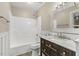 Bathroom features tub and shower combination, updated vanity, and decorative mirror at 366 E Smithfield St, Angier, NC 27501