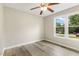 Bright bedroom features window and wood-look flooring at 366 E Smithfield St, Angier, NC 27501