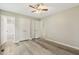 Bright bedroom features wood-look flooring and double closets leading to bath at 366 E Smithfield St, Angier, NC 27501