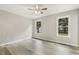 Bright bedroom features two windows and wood-look flooring at 366 E Smithfield St, Angier, NC 27501