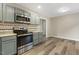 Kitchen showcasing stainless steel appliances, ample counter space and access to dining area at 366 E Smithfield St, Angier, NC 27501