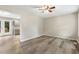 Open-concept living room with wood-look flooring, neutral walls, and access to kitchen at 366 E Smithfield St, Angier, NC 27501