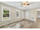 Inviting living room featuring wood-look floors, ceiling fan and a closet for storage at 366 E Smithfield St, Angier, NC 27501