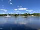 Scenery of the pond showcasing a beautiful water fountain, blue sky, and lush trees at 366 E Smithfield St, Angier, NC 27501