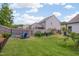Spacious backyard with a fire pit area, garden beds, and a well-maintained lawn surrounded by a wood fence at 40 Bourne Dr, Franklinton, NC 27525