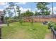 Expansive backyard with lush landscaping, a fire pit area, and a privacy fence creating a serene outdoor space at 40 Bourne Dr, Franklinton, NC 27525