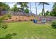 Beautiful backyard with a grassy lawn, a cozy fire pit area, and a wood privacy fence surrounding the property at 40 Bourne Dr, Franklinton, NC 27525
