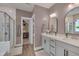 Modern bathroom featuring double vanity, walk-in shower, and a doorway to a walk-in closet at 40 Bourne Dr, Franklinton, NC 27525
