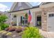 A relaxing front porch with a patriotic touch, featuring an American flag, plants, and cozy seating at 40 Bourne Dr, Franklinton, NC 27525