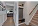 Hallway featuring wainscoting detail, wood floors, and stairs, leading into an open-concept living space at 40 Bourne Dr, Franklinton, NC 27525