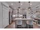 Bright kitchen featuring an island with seating, stainless steel appliances, and modern pendant lights at 40 Bourne Dr, Franklinton, NC 27525