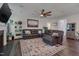 Comfortable living room features a leather sectional, ceiling fan, fireplace, and a decorative rug at 40 Bourne Dr, Franklinton, NC 27525