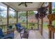 Relaxing screened-in porch with comfortable wicker seating, potted plants, and views of the landscaped backyard at 40 Bourne Dr, Franklinton, NC 27525