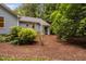 Landscaped backyard featuring mature trees at 4004 Bamburgh Ln, Apex, NC 27539