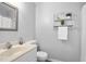 Clean bathroom featuring a vanity and decorative shelf at 4004 Bamburgh Ln, Apex, NC 27539